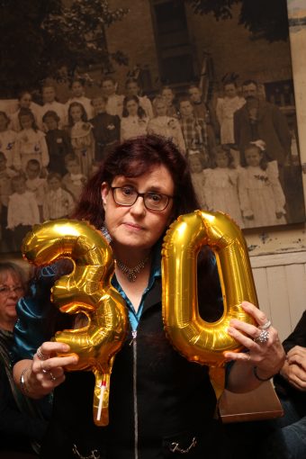 Staff holding 30 years of service balloons.