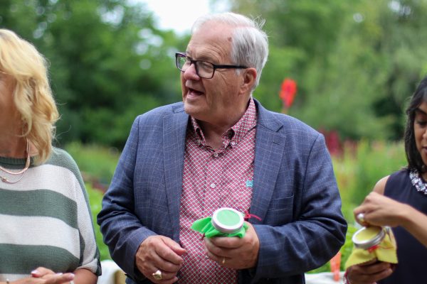 The Minister of Agriculture the Honourable Lawrence Mac Aulay smiling with homemade raspberry jam from Our Farm.