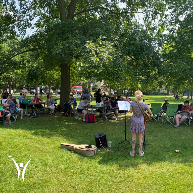 People dancing, singing, and enjoying the bring along sing along event in the park!