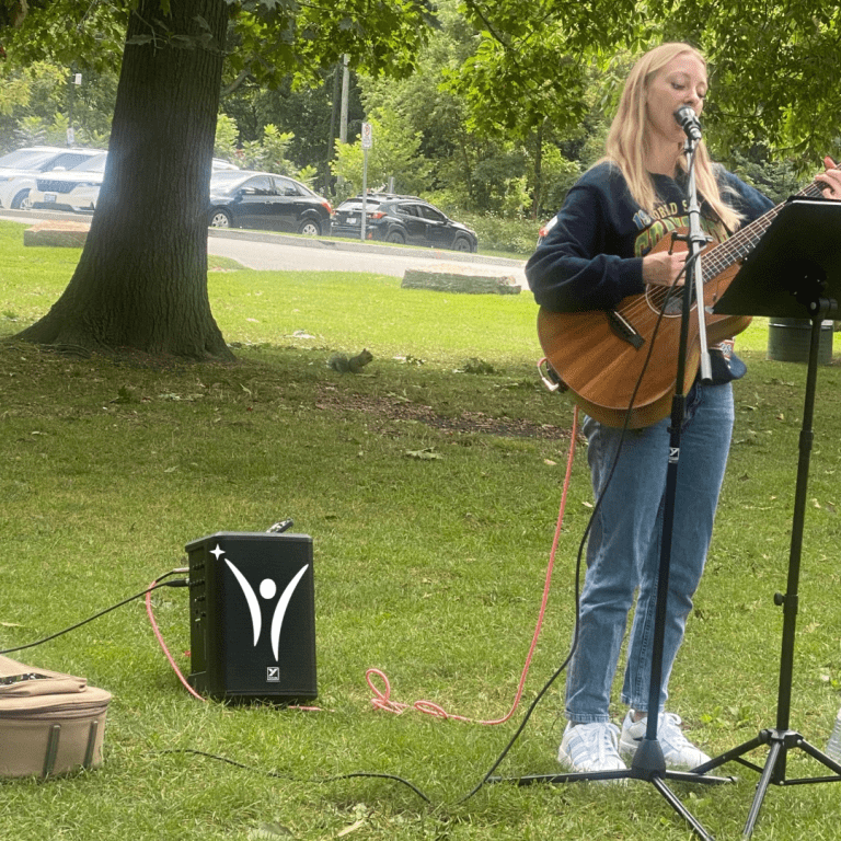 People dancing, singing, and enjoying the bring along sing along event in the park!