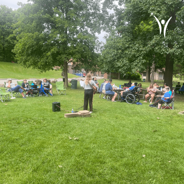 People dancing, singing, and enjoying the bring along sing along event in the park!