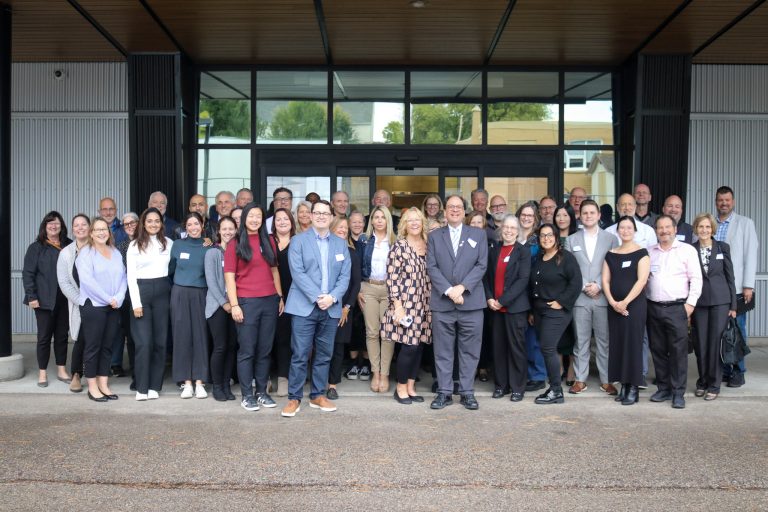 Guests of the ICC Housing Forum gathered together for a group photo outside of KW Habilitation.