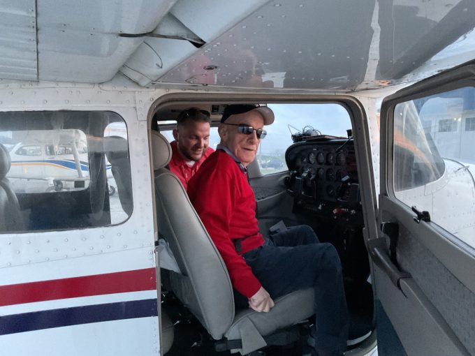 Tony and pilot in an airplane preparing for take off.