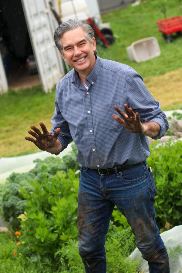 MP Tim Louis harvesting carrots at Our Farm.