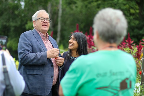 The Minister of Agriculture the Honourable Lawrence Mac Aulay and MP Bardish Chagger smiling after tasting fresh tomatoes from Our Farm.