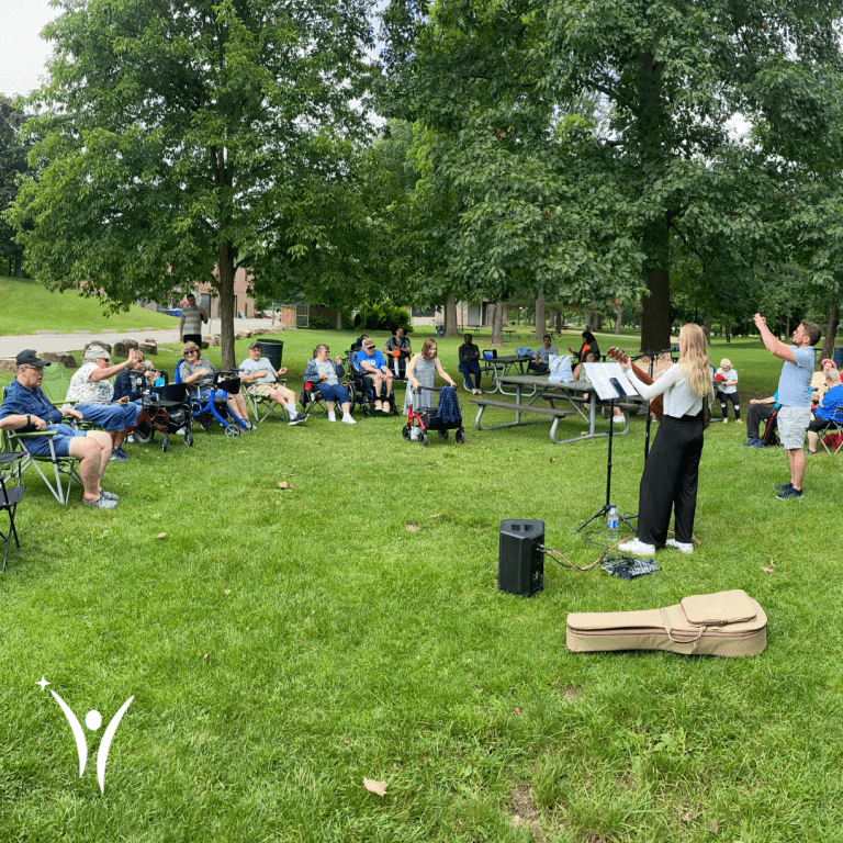 People dancing, singing, and enjoying the bring along sing along event in the park!