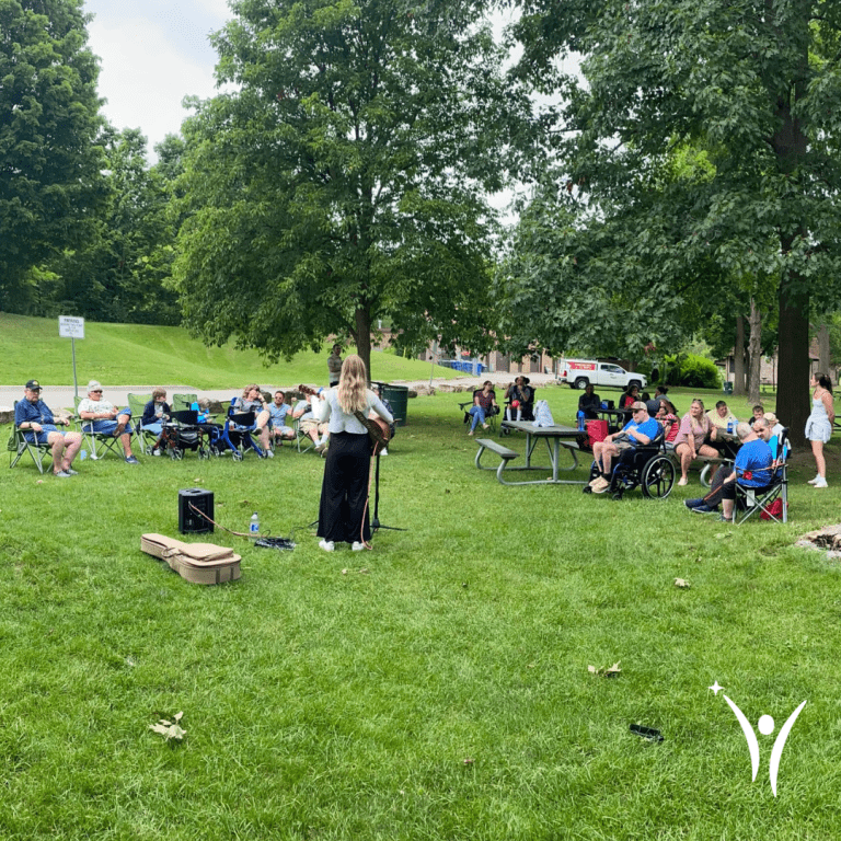 People dancing, singing, and enjoying the bring along sing along event in the park!