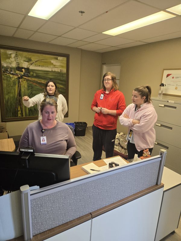 Robert working with skills trainers at his internship at the Cambridge Memorial Hospital.