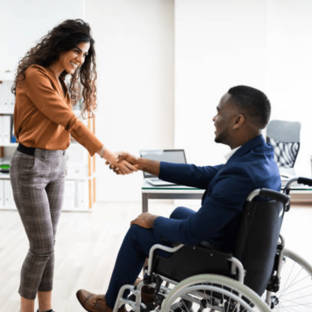 Person at a job interview shaking hands.