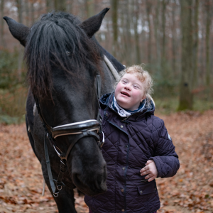a person walking alongside a horse