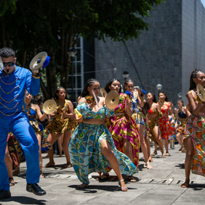 A group of dancers wearing bright coloured clothing.