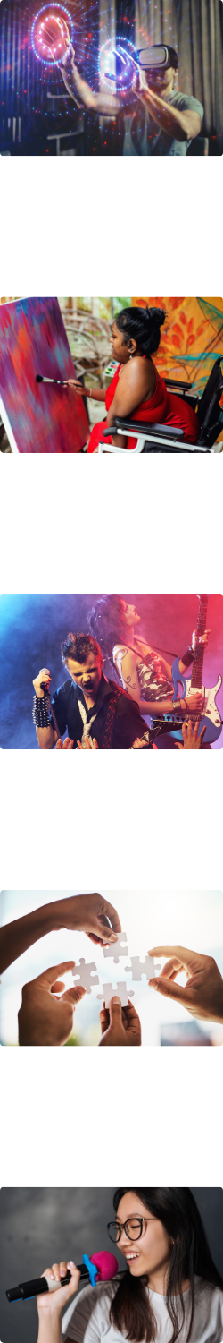 A person wearing a virtual reality headset and interacting with the perceived images. A person making a colourful painting. Two rock and roll performers, one with a microphone and one with an electric guitar. Four puzzle pieces being held up together by four different hands. A person singing into a microphone.
