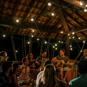 A group of people gathering together to make music with acoustic instruments.