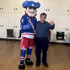 A person giving a thumbs up while meeting Ranger Tex, the mascot of Kitchener Rangers.
