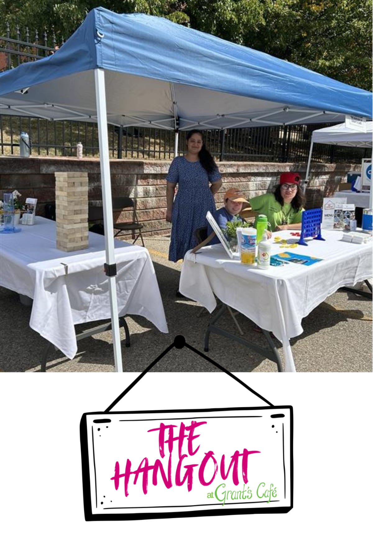 Volunteers at an information booth for The Hangout at Grant's Cafe. Various games set up to play like connect four and giant jenga. The Hangout logo.