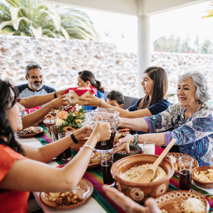 A group of people sharing a meal of traditional Mexican cuisine.