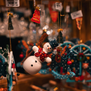 An array of hand painted tree ornaments for sale.