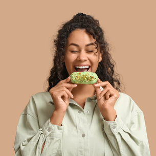 A person smiling about to eat a delicious treat.