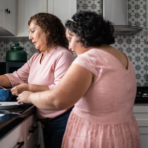 two people cooking in a kitchen