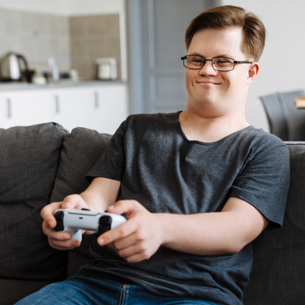 A person with a video game controller smiling