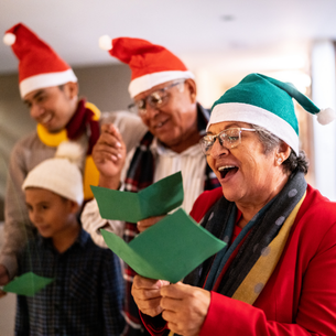 People wearing festive red and green hats while singing a song together