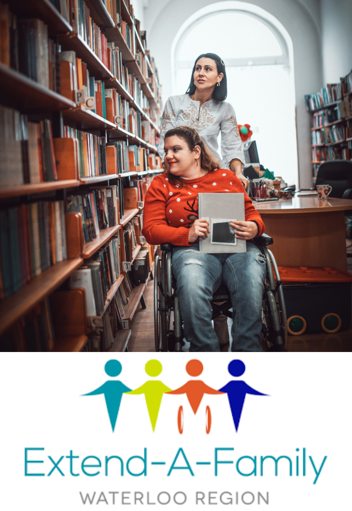 A person using a wheelchair with another person helping. They are in a library and looking at the books on the shelf. The Extend-A-Family Waterloo Region Logo.