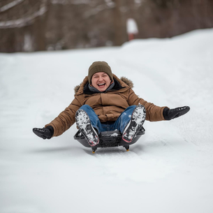 A person sledding down a snowy hill.