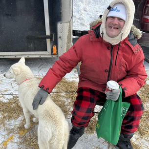 David petting one of the sledding dogs.