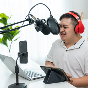 A person using a special microphone in a recording studio.