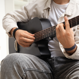 A person playing an acoustic guitar.