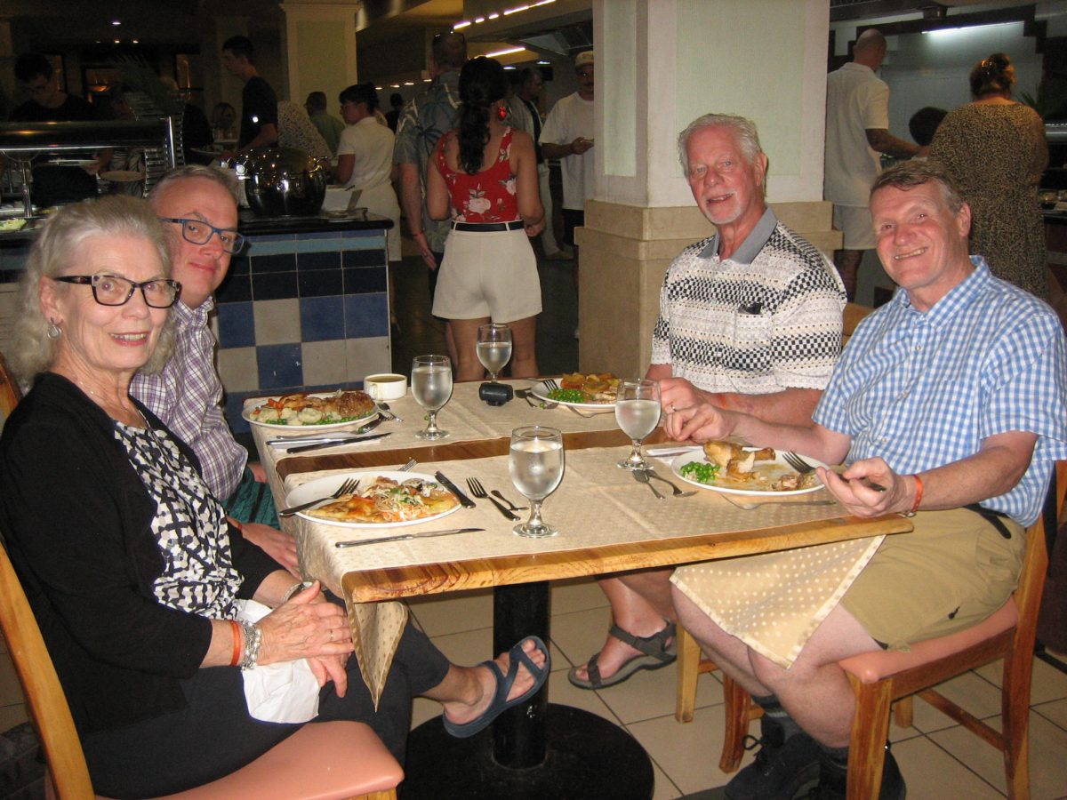 photo of four adults at a table at a restaurant in Cuba