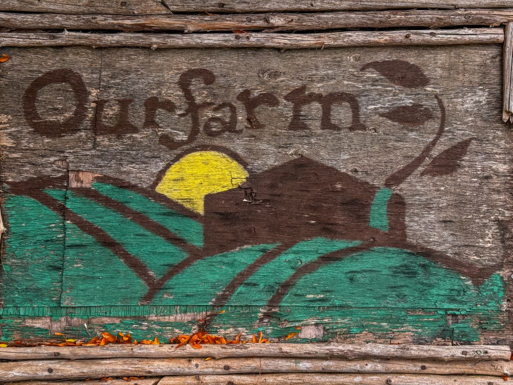 the our farm logo painted on wood