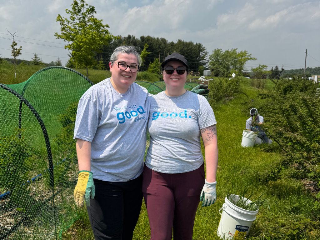 two people smiling at the farm