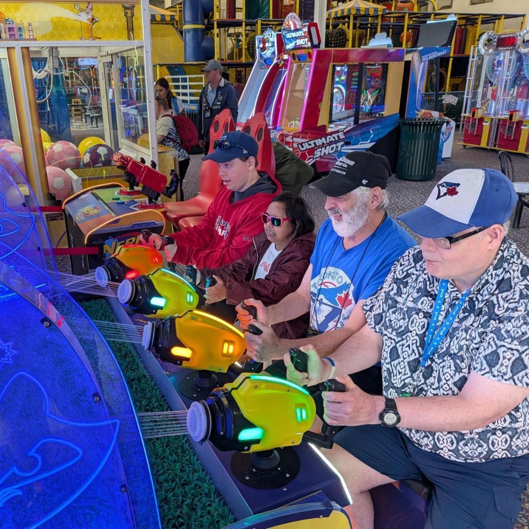 group of adults playing a water game at an arcade