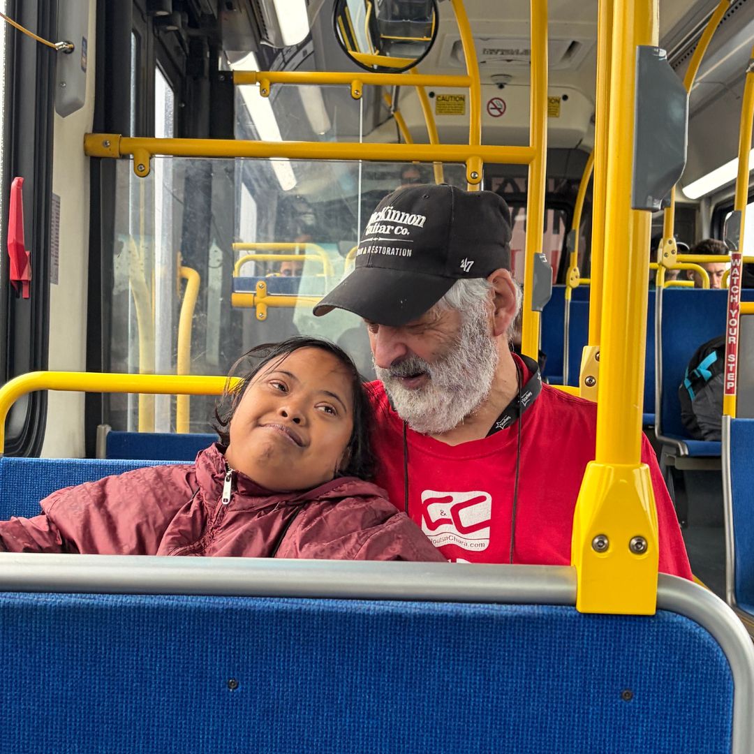 two people sitting together on the bus