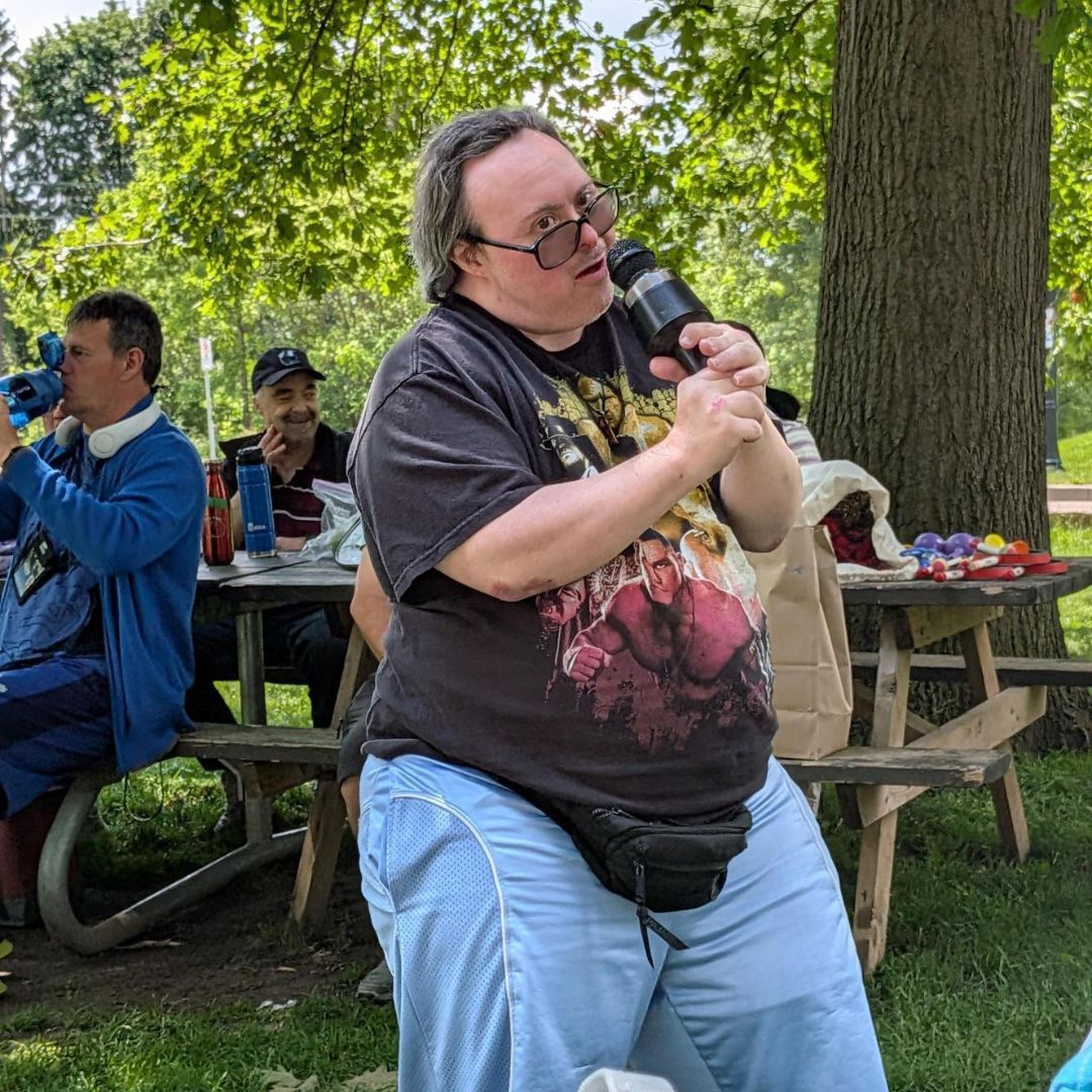 man with Down syndrome in the park singing karaoke