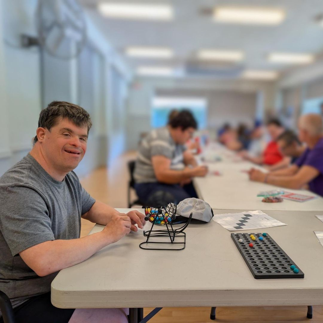 man playing bingo with others in the background