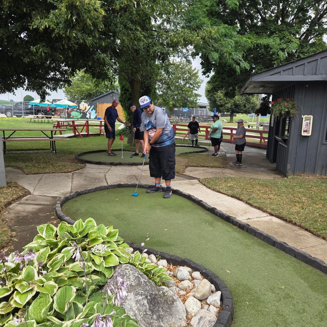 man playing mini golf