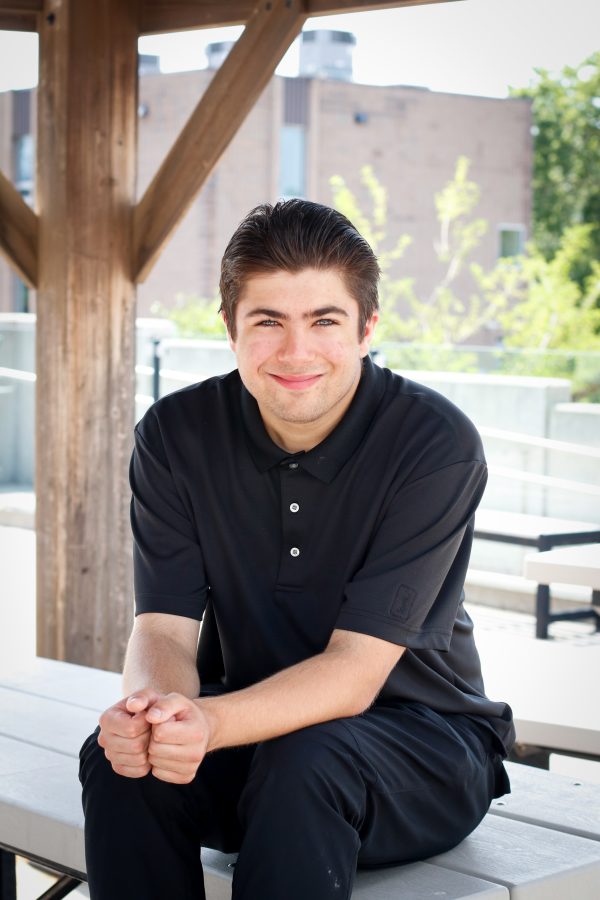 photo of Anthony, a young man smiling with brown hair and wearing a black shirt.