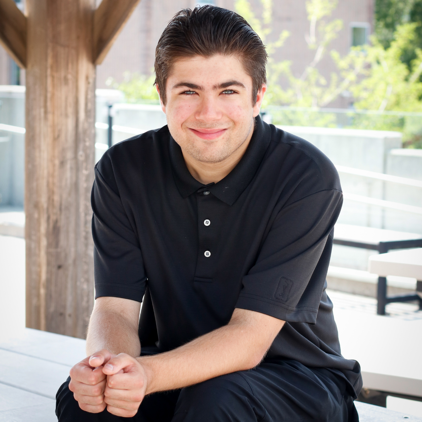 photo of Anthony, a young man smiling with brown hair and wearing a black shirt.